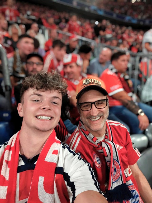 student with host dad at the football game in Germany