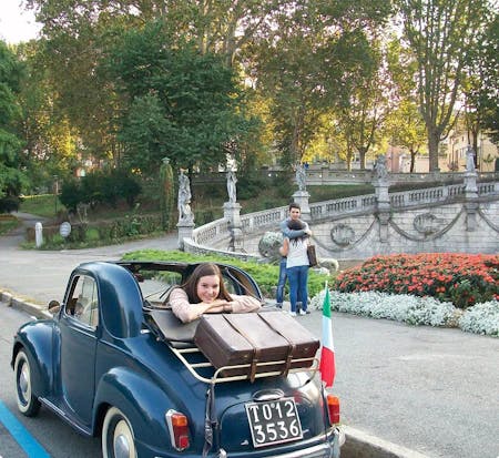 student in vintage car