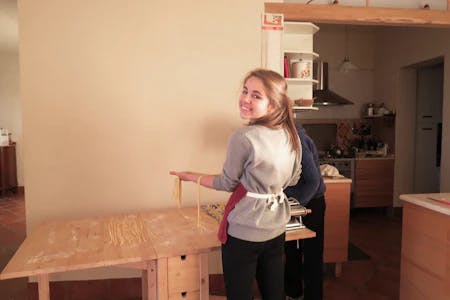 student cooking fresh pasta